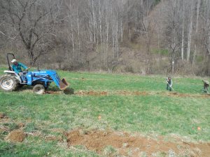 Anna and Greg raking the sod away from the planting holes